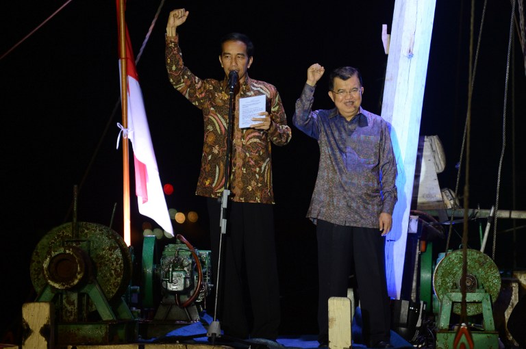 MERDEKA! President-elect Joko Widodo and Vice-president-elect Jusuf Kalla raise their fists as they shout "Merdeka!" or "Freedom!" during their victory speech aboard a traditional boat in North Jakarta on July 22, 2014. Photo by Romeo Gacad/AFP