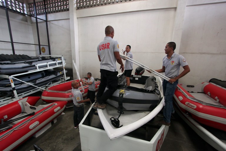 RESCUE EFFORTS. Rescuers prepare their equipments at their quarters in Davao City, in southern island of Mindanao for Typhoon Bopha. Photo by AFP.