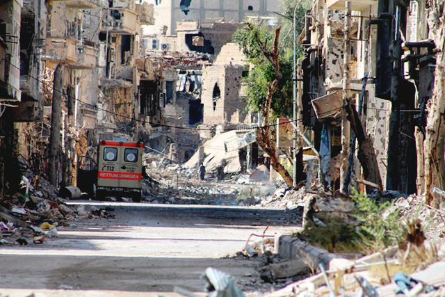  A general view shows a heavily damaged street in Syria's eastern town of Deir Ezzor on August 26, 2013. Syria's opposition accused pro-regime forces of opening fire at United Nations weapons inspectors on their way to a suspected chemical weapons site outside Damascus in a bid to hinder their investigation. Photo by AFP / AHMAD ABOUD