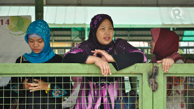 WORLD HIJAB DAY. These 3 ladies watch as non-Muslims try the hijab. All photos by Jay Ganzon