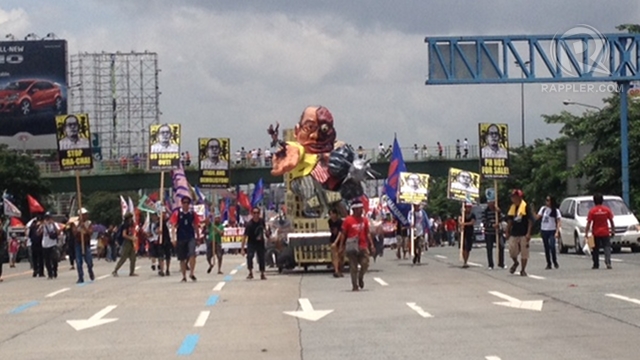 KILLER HIGHWAY. President Benigno Aquino III's effigy traverses Commonwealth Avenue, the Philippines' so-called killer highway, for a rally during the President's State of the Nation Address. Photo by Paterno Esmaquel II