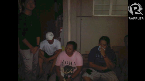LOYALTY. Former employees of Secretary Robredo wait outside his house for updates on his condition. Photo by Raffy Magno