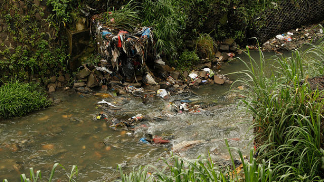 LEFT OVERS. Trash lines a river in the center of Bandung, West Java in Indonesia