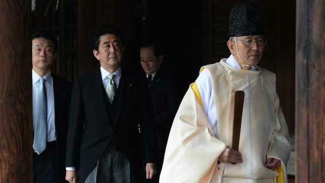 CONTROVERSIAL: A Shinto priest leads Japanese Prime Minister Shinzo Abe as he visits the controversial Yasukuni war shrine in Tokyo. AFP photo 