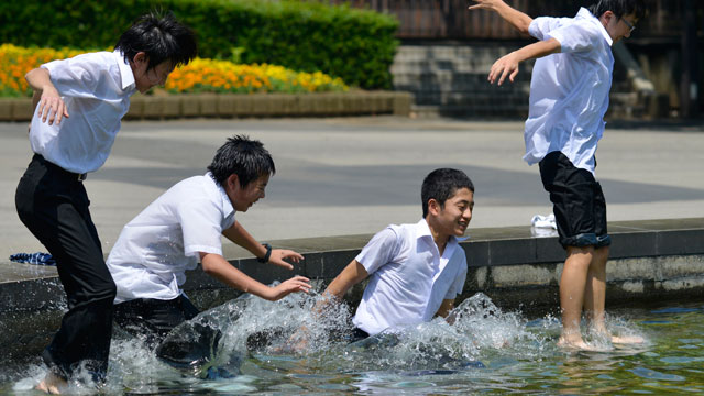 TOKYO, Japan – Middle school students jump into a fountain to cool down at a park in central in Tokyo, July 8, 2013. A heat wave is hitting Japan as the rainy season ended earlier than usual almost all over the country. Temperatures soared to 35 degrees Celsius in Tokyo and reached 38 degrees Celsius in central Japan. Photo by Franck Robichon/EPA