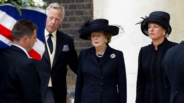 2003, July 3. Lady Margaret Thatcher (C) with her son Mark (L) and her daughter Carol (R) watches the coffin of her husband Sir Denis Thatcher during his funeral at the Royal hospital, Chelsea, in London. Sir Denis Thatcher, the discreet pillar of strength behind Britain's first woman prime minister Margaret Thatcher, died on June 26, 2003, at the age of 88. AFP/Nicolas Asfouri