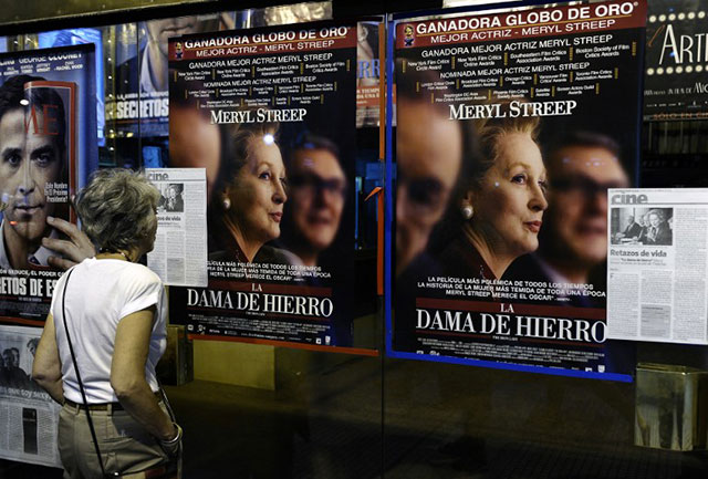 2012, February 2. A woman looks at the posters of the The Iron Lady movie --a biographical film about Margaret Thatcher-- in front of a cinema in Buenos Aires. The movie was premiered in Argentine theaters amid a furor over the Falkland Islands, which Thatcher's Britain and Argentina fought a bloody war 30 years ago. AFP/Alejandro Pagni