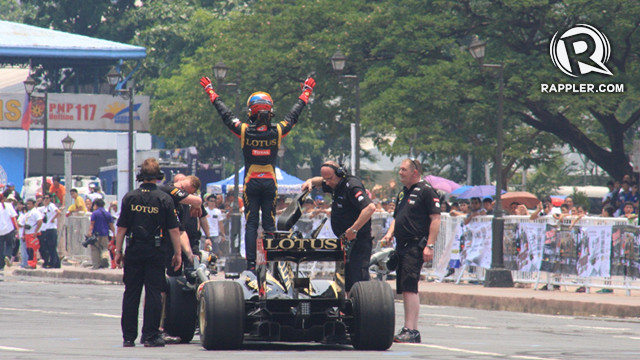 Marlon stands atop his racecar at the Quirino Grandstand after completing a lap