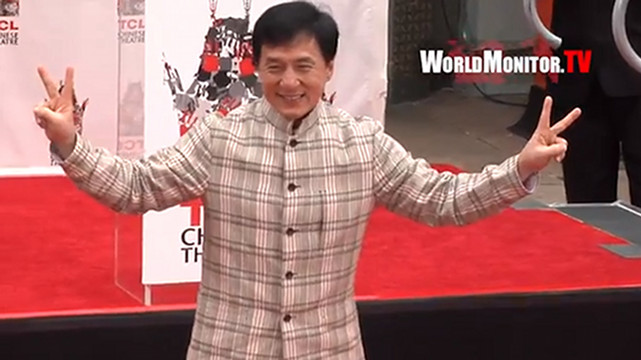 SECOND TIME AROUND. Jackie Chan smiles sweetly at the media as he stood on the cement that would seal his prints at the TCL Chinese Theatre in Hollywood. Screen grab from YouTube (TheWorldmonitortv)
