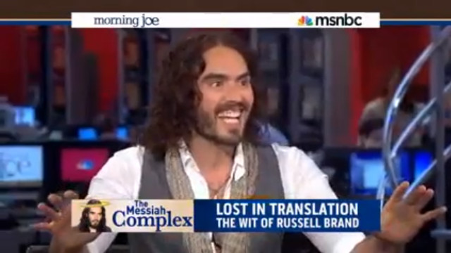 BRAND STRIKES BACK. Comedian Russell Brand lectures 3 morning show hosts on basic good manners. Screen grab from YouTube (OvergrowDaGovernment)