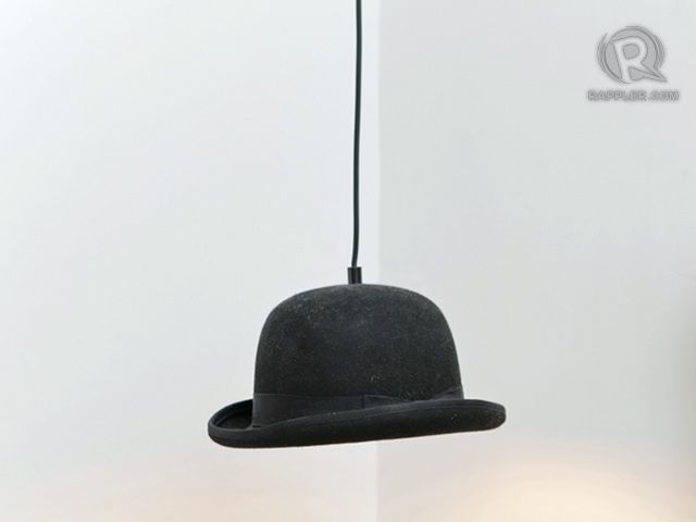 A bowler hat hangs from the bedroom ceiling