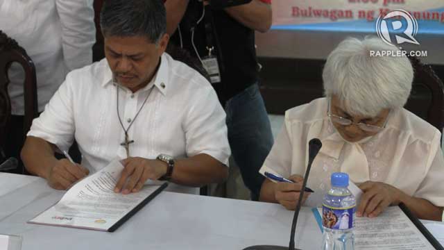 SIGNED. DepEd Secretary Br Armin Luistro and NCIP Chairperson Zenaida Pawid sign a MOA for the use of IPs ancestral domains as school sites. Photo by Jee Geronimo/Rappler