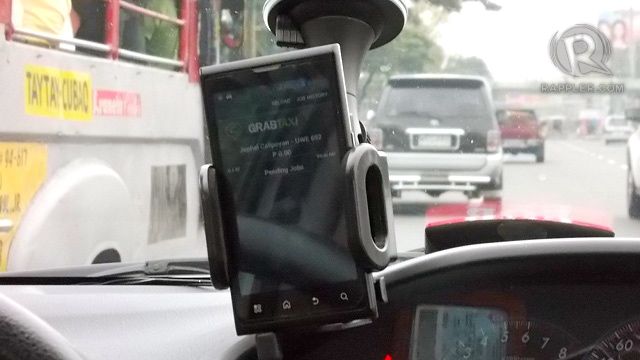 MAKE SURE TO SEE THIS. A Cloud phone with the GrabTaxi app is installed in the cab's windshield