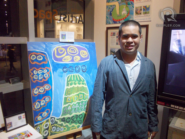 PRIZE-WINNING WORK. J.A. with his painting, 'Victory.' Photo by Peter Imbong