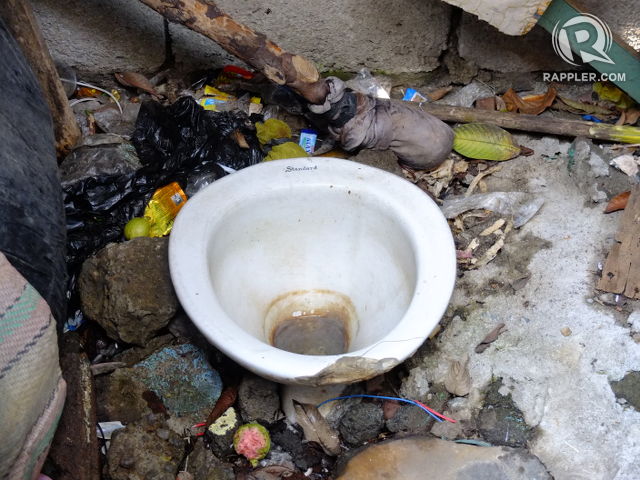 NOWHERE ELSE TO GO. A toilet beside the creek deposits human waste into the body of water