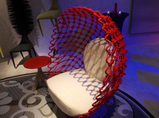 DRAGNET CHAIR. In vibrant red, the Dragnet Chair is made of polycotton and stainless steel
