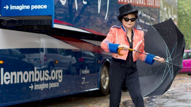 PEACE. Yoko Ono poses in front of the John Lennon Educational Tour Bus. Photo: Tim Brakemeier/AFP