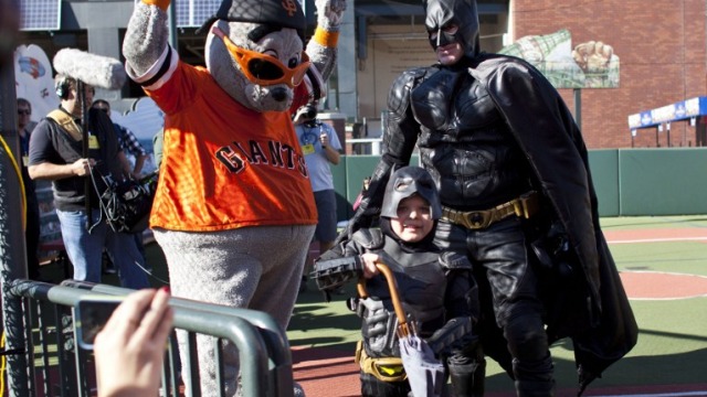 SAVES THE DAY. Batkid and Batman release San Francisco Giants mascot Lou Seal from the Penguin. Photo by Ramin Talaie/Getty Images/AFP