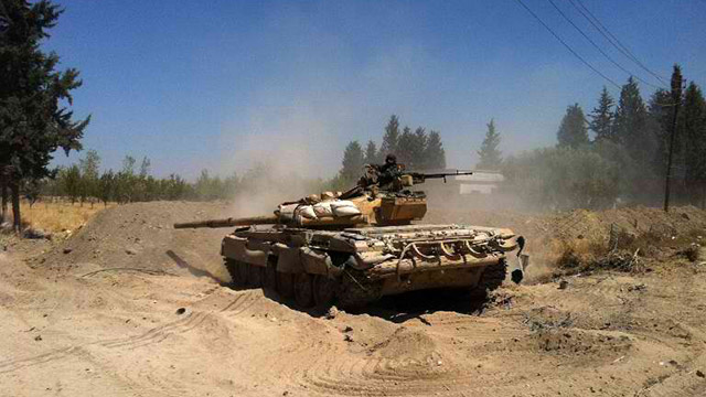 CONFLICT-RIDDEN SYRIA. A Syrian army tank maneuvers in the Eastern Ghouta area on the northeastern outskirts of Damascus on August 30. Photo by Sam Skaine/AFP
