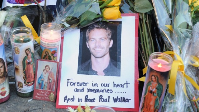 IN MEMORIAM. A photo of actor Paul Walker among flowers and candles left by fans at the site of the car accident. Photo by Topshots/AFP/Robyn Beck