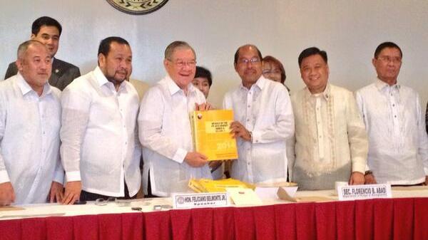 FUNDS. Budget Secretary Butch Abad submits the proposed 2014 budget to Speaker Sonny Belmonte. Photo by Rappler