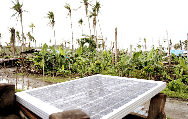 HARNESSING SUNLIGHT. A 50-watt solar panel converts sunlight into electricity to power a home in Tanauan, Leyte. Photo by Nim Gonzales