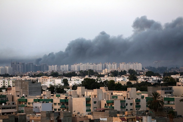 Smoke fills the sky over Tripoli after fighting between militias of 'Libya Fajr' (Dawn of Libya) and 'Karama' (Dignity) in Tripoli, Libya, 23 August 2014. Stringer/EPA