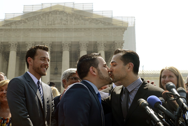 Paul Katami and Jeffrey Zarrillo kiss after Katami asked Zarrillo to marry him before members of the media, outside the Supreme Court in Washington DC after the US Supreme Court struck down as unconstitutional a federal law that prohibits the US government from recognizing gay marriage and providing benefits to same-sex couples. Photo by EPA/Michael Reynolds