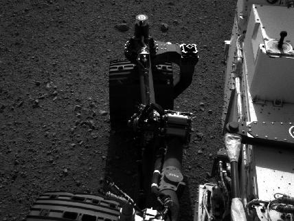 TESTING. View of the rear right wheel of NASA's Curiosity as rover drivers turned the wheels in place at the landing site on Mars. Image credit: NASA/JPL-Caltech 