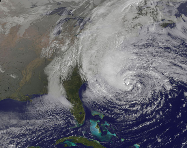 NOAA's GOES-13 satellite captured this visible image of the massive Hurricane Sandy on Oct. 28 at 1302 UTC (9:02 a.m. EDT). The line of clouds from the Gulf of Mexico north are associated with the cold front that Sandy is merging with. Sandy's western cloud edge is already over the mid-Atlantic and northeastern United States. (Credit: NASA GOES Project)