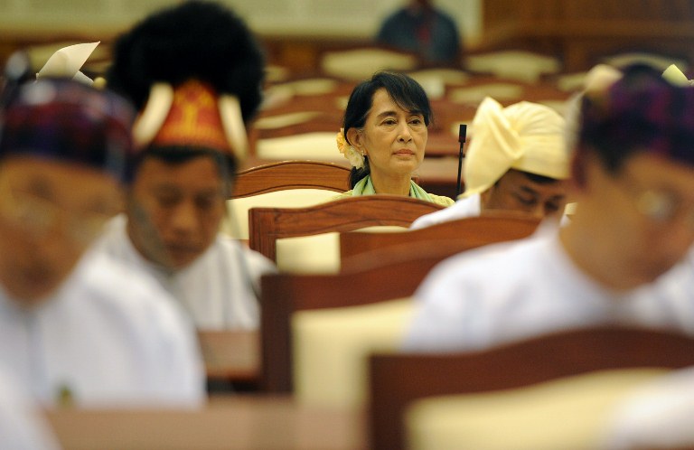 Myanmar opposition leader Aung San Suu Kyi (C) attends the lower house parliament session in Naypyidaw on July 9, 2012. Suu Kyi made her historic parliamentary debut on July 9, marking a new phase in her near quarter century struggle to bring democracy to her army-dominated homeland. AFP PHOTO / Soe Than WIN