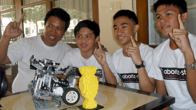 ROBOTICS CONTENDERS. Aboitiz STEC Robotics Team Syrum Quinto, Kent Tiu, and Keenu Manayon with their coach, Donald Dungon 
