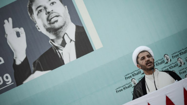 FREE BUT NOT FREE. Bahrain's Al-Wefaq opposition group leader Sheikh Ali Salman (right) speaks during a rally in support of detained former Shiite opposition MP Khalil Marzuq. File photo by MOHAMMED AL-SHAIKH/AFP