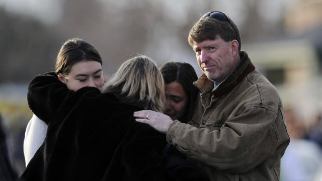 SCHOOL SHOOTING. Family and friends comfort each other outside Shepherd of the Hills Church after a school shooting at Arapahoe High School on December 13, 2013 in Centennial, Colorado. Photo by Chris Schneider/AFP
