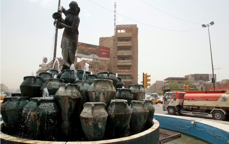 Water flows from the Kahramna Square fountain, which depicts a scene from the "1001 Nights" tales, in central Baghdad on July 31, 2012. Baghdad was once the capital of an empire and the centre of the Islamic world, but at 1,250 years old, the Iraqi city is a far cry from its past glories after being ravaged by years of war and sanctions. AFP PHOTO/ALI AL-SAADI