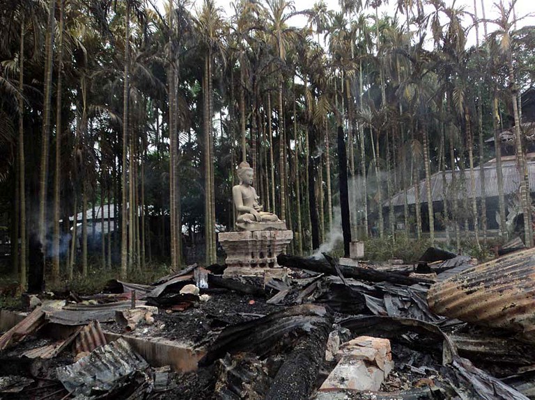 BURNED TEMPLE. A statue of Lord Buddha is left standing amidst the torched ruins of the Lal Ching Buddhist temple at Ramu, some 350 kilometers (216 miles) from the capital Dhaka on September 30, 2012. Thousands of rioters torched Buddhist temples and homes in southeastern Bangladesh Sunday over a photo posted on Facebook deemed offensive to Islam, in a rare attack against the community. AFP PHOTO