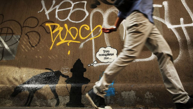 INCOGNITO. A person walks by a new Bansky work at a wall in New York