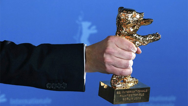 GOLDEN BEAR. The Golden Bear award for the Best Film is held by winner Calin Peter Netzer for the film "Pozitia Copilului" (Child's Pose) during the 63rd Berlinale Film Festival in Berlin AFP PHOTO/THOMAS PETER