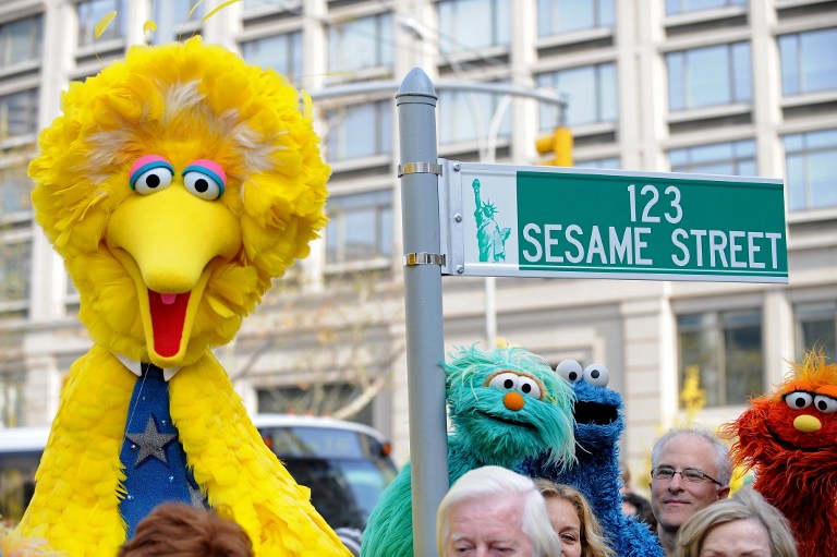 Big Bird (L) and other Sesame Street puppet charactors pose next to temporarty street sign November 9, 2009 at West 64th Street and Broadway in New York on the eve of the 40th anniversary of the broadcast of the children's television show. AFP PHOTO/Stan Honda