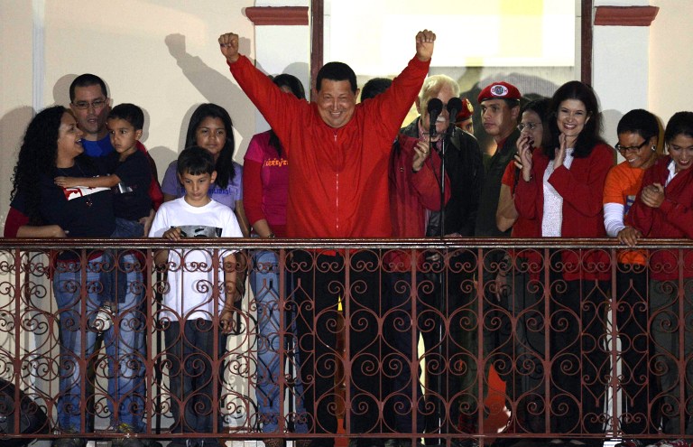 VICTORY. Venezuelan President Hugo Chavez (C) gestures while speaking to supporters after receiving news of his reelection in Caracas on October 7, 2012. According to the National Electoral Council, Chavez was reelected with 54.42% of the votes, beating opposition candidate Henrique Capriles, who obtained 44.47%. AFP PHOTO/JUAN BARRETO