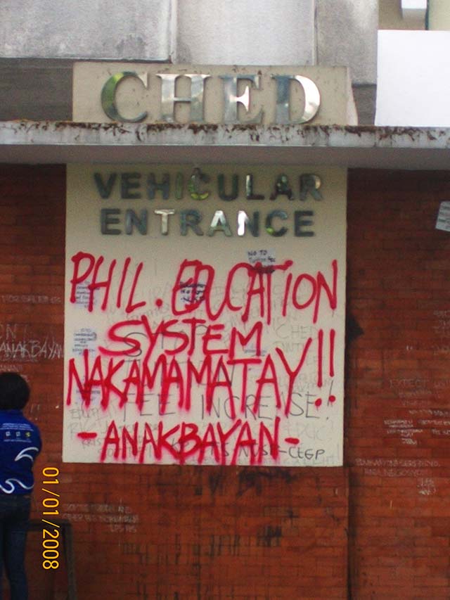 MILITANT SLOGAN. The slogan criticizing the Philippine educational system is written on the walls flanking the CHED entrance. Photo by Susan F Quimpo