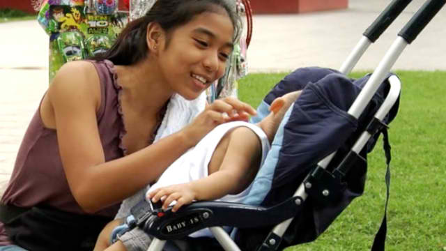 CHILDREN BEARING CHILDREN. A teenage mother cares for her child. Screengrab of a UNFPA educational video courtesy of UNFPA Philippines
