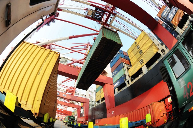 CHINA TRADE. This picture taken on September 9, 2012, shows containers being loaded by workers at Qingdao Port, east China's Shandong province. AFP PHOTO