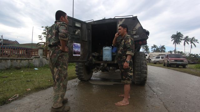 BAREFOOT SOLDIERS. Troops help in continued search and rescue operations in Compostela Valley, one of the hardest hit areas by typhoon Pablo. Photo by Karlos Manlupig 