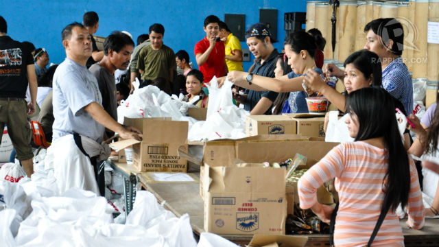 HELPING HAND. Volunteers pack relief goods for Typhoon Maring victims in DSWD's National Resource Operation Center. Photo by Jay Ganzon