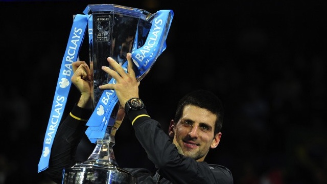 VICTORIOUS. Serbia's Novak Djokovic poses with the winners' trophy after the singles final against Switzerland's Roger Federer on the eighth day of the ATP World Tour Finals tennis tournament in London on November 12, 2012. AFP PHOTO / GLYN KIRK