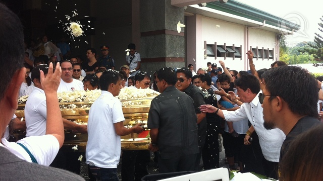 BURIAL. Dolphy's remains were encased in a glass-topped golden metal casket that he himself bought in the 1970s. It is shown here carried by pall bearers from the chapel to the nearby burial site. Photo by Natashya Gutierrez
