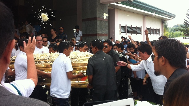 GOODBYE. Relatives and friends carry Dolphy's coffin from the chapel, where the final service was heard, to the burial site. Photo by Natashya Gutierrez