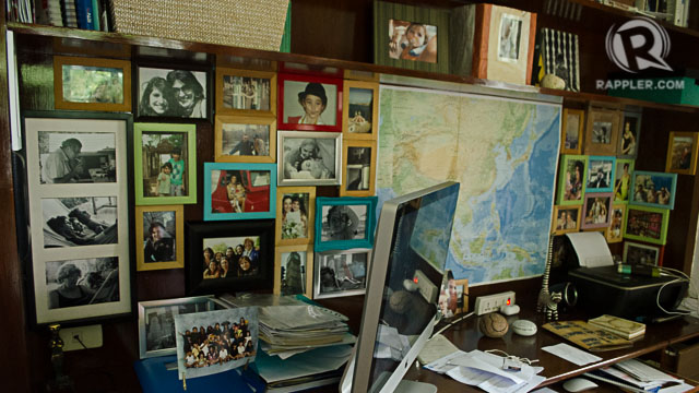 FAMILY. A map hangs on a wall of their home along with more family photos
