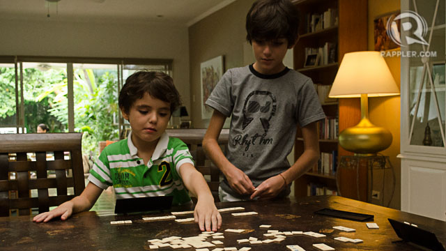 PLAY. Tobeas (L) and Luca (R) playing Rummikub — a tiled game of numbers that makes kids good in math.